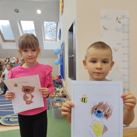 Fotografia kolorowa. Dzieci i ich misiowe prace plastyczne.