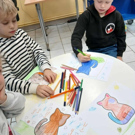 Fotografia kolorowa. Dzieci wykonują prace plastyczne.